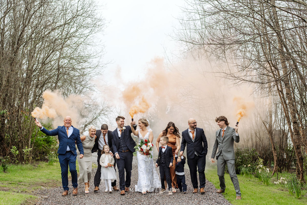 Winter wedding photo with coloured smoke in the grounds